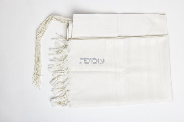 White-on-white machine-made tallit folded with matching atarah
