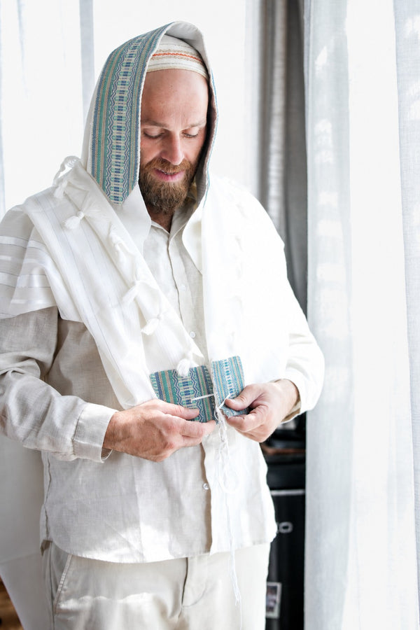 Gan Eden white wool tallit with turquoise and blue geometric handwoven atarah.