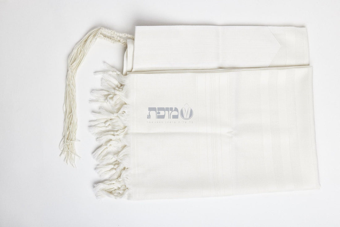 White-on-white machine-made tallit folded with matching atarah